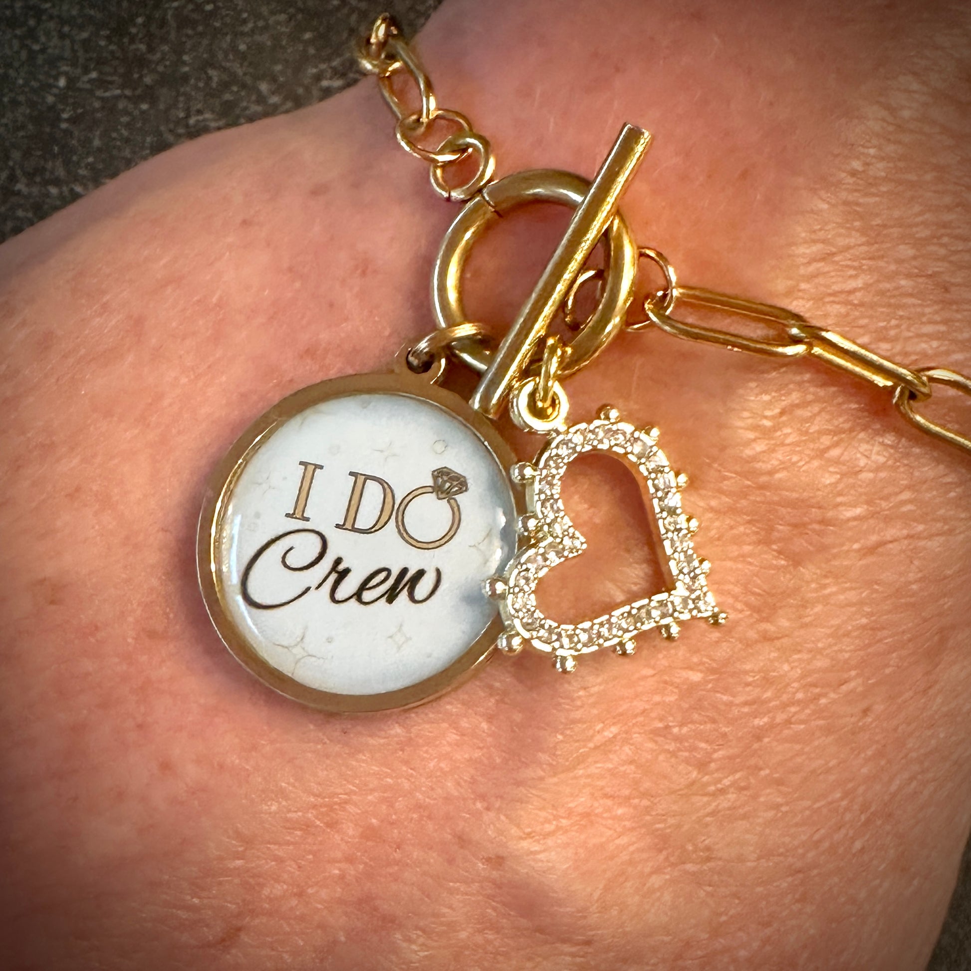 I do crew with heart rhinestone charm.  paperclip gold bracelet