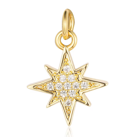 Gold starburst charm with sparkling crystals, perfect for bracelets or necklaces.